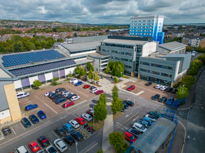 Aerial view of Highbury Campus buildings with rooftop solar panels and car parking