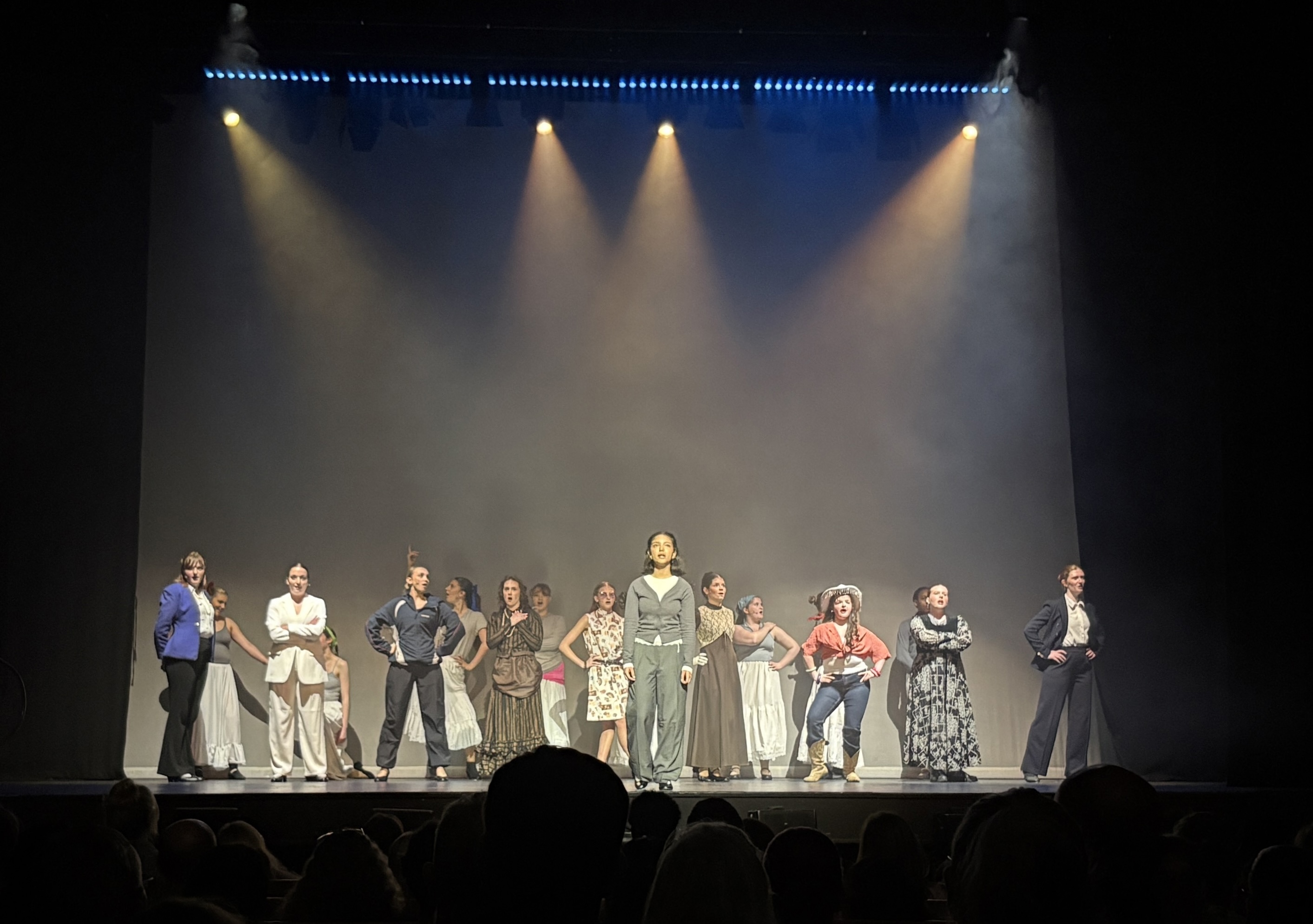 The cast of Pinnacle on stage performing an ensemble number