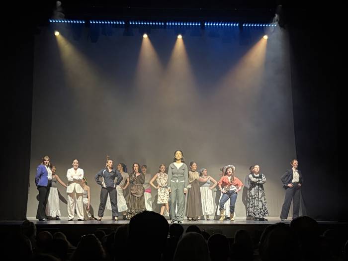 The cast of Pinnacle on stage performing an ensemble number