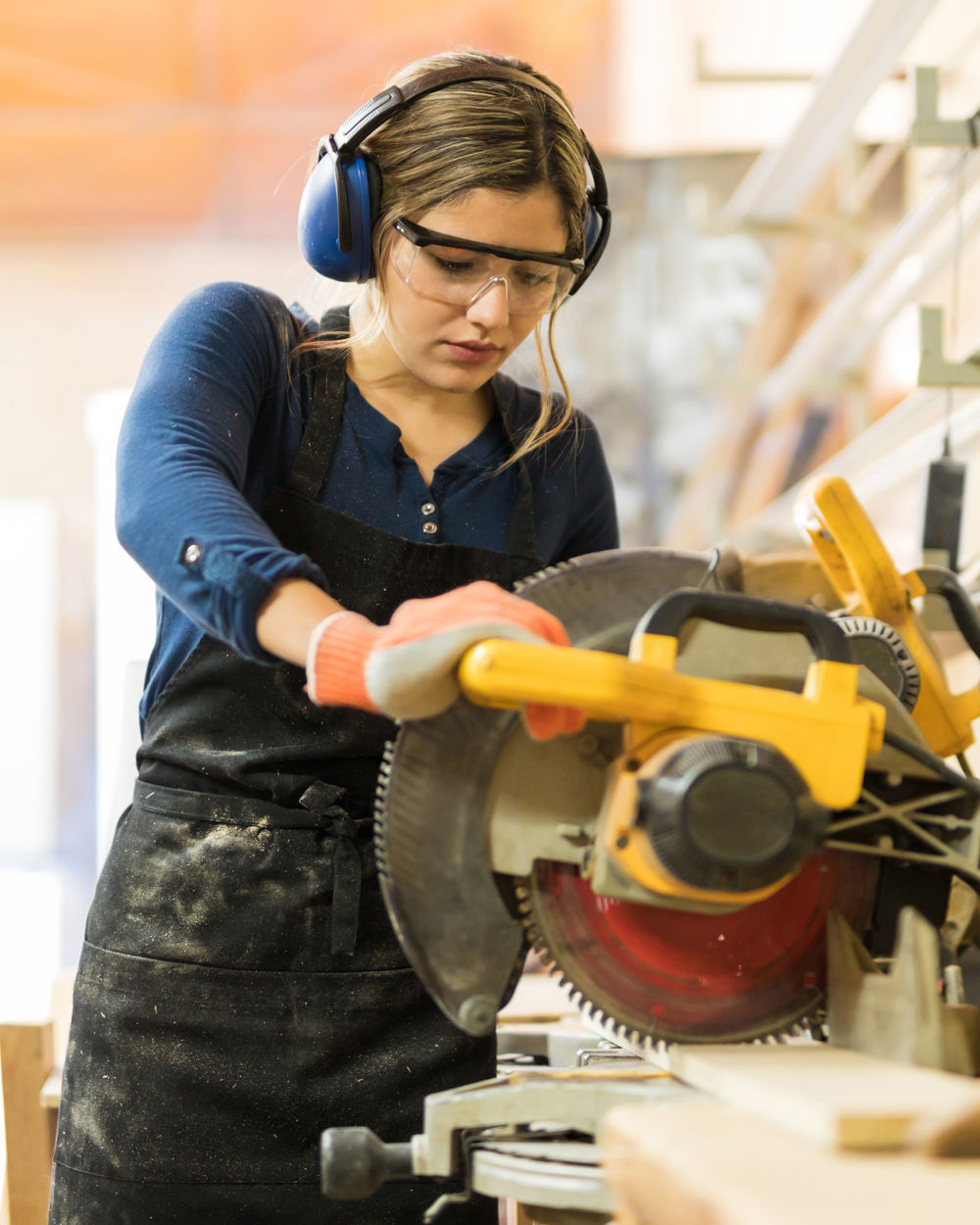  female carpentry student using some power tools for her work