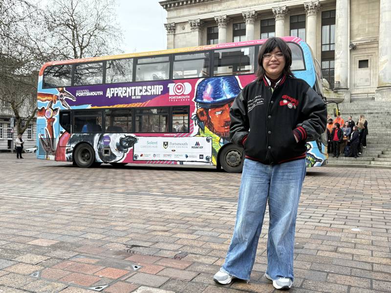 Anya Velez in front of the Apprenticeship Bus she designed through a competition.