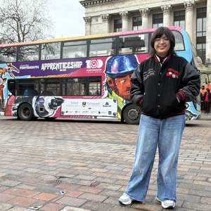 Anya Velez in front of the Apprenticeship Bus she designed through a competition.