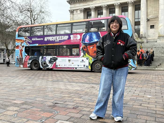Anya Velez in front of the Apprenticeship Bus she designed through a competition.
