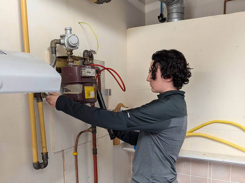 Gas engineer carrying out testing and commissioning on a gas meter and appliance during CMA2LS and MET3LS gas safety training.
