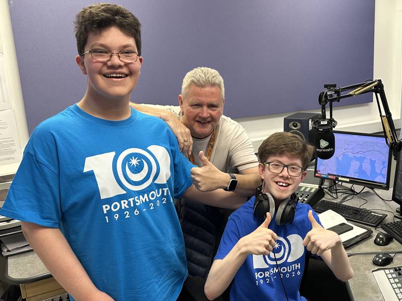 Students Daniel Runham and James Rogers at the Express FM mixing desk with presenter Ian James