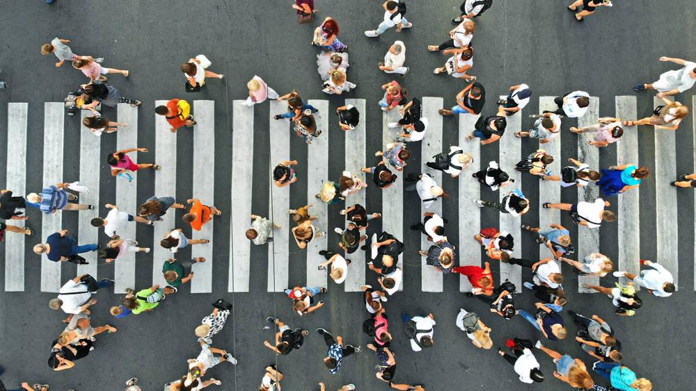People crowd on pedestrian crosswalk. Top view.