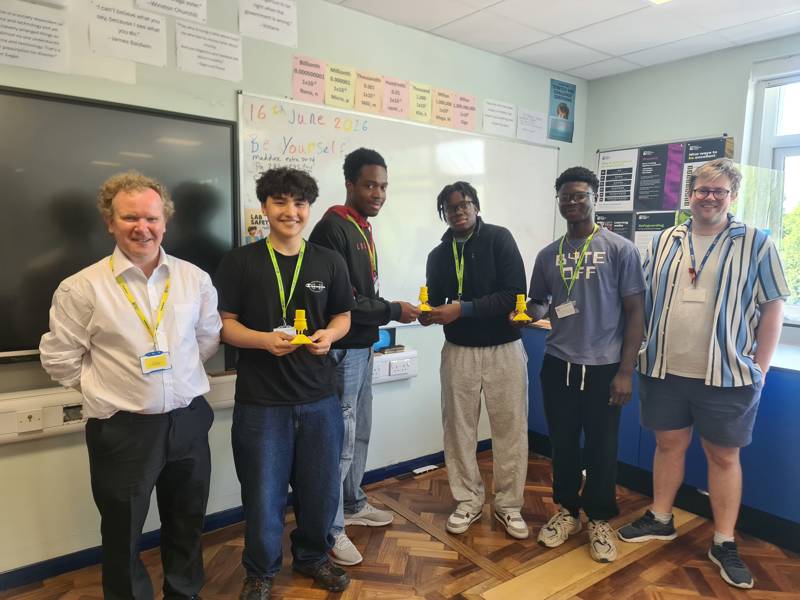 Physics students celebrate their win with Physics lecturer Joseph Blake and University of Portsmouth's David Bacon