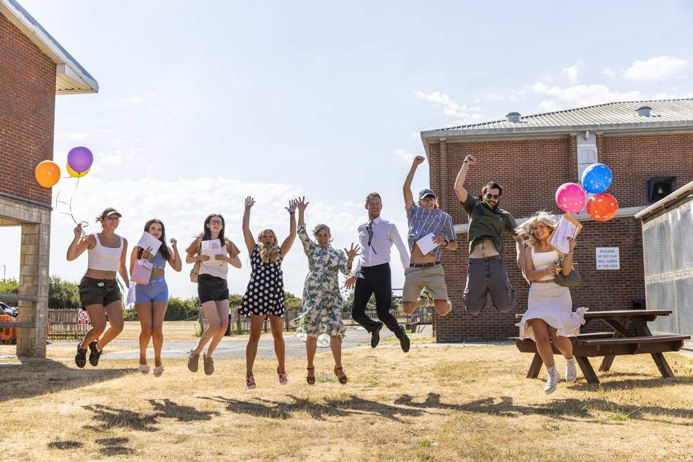Students jump for joy at Sixth Form Campus alongside MPs Amanda Martin and Stephen Morgan, and Emily Pountney, Deputy Principal - Quality & Innovation