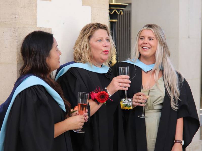 COPC graduates enjoying a celebratory drink outside the Portsmouth Cathedral.