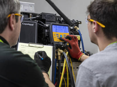 Two male students conduction a gas system check 