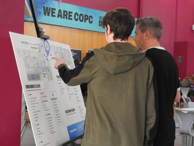 Two people refer to a campus map