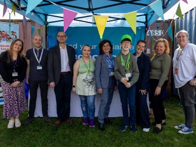 Organisers and staff members pose together outside the Moving Forward 2026 event