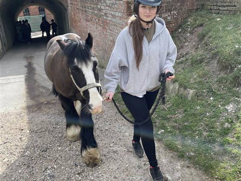 COPC Animal Care student leading a pony through tunnel at Fort Widley.