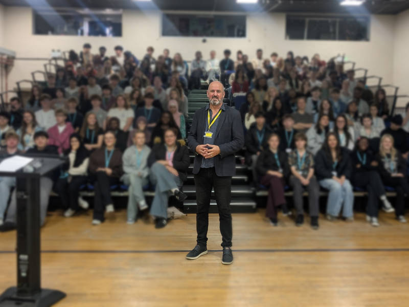Richard Higginson, centre, stands in front of A Level Psychology students at Sixth Form Campus