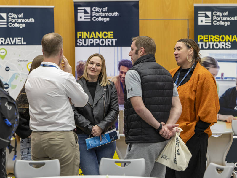 Parents talking to staff at City of Portsmouth College Open Event 