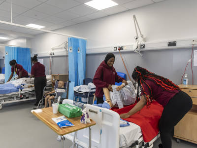 Health and social care students practising patient care in a simulated hospital ward at Highbury Campus