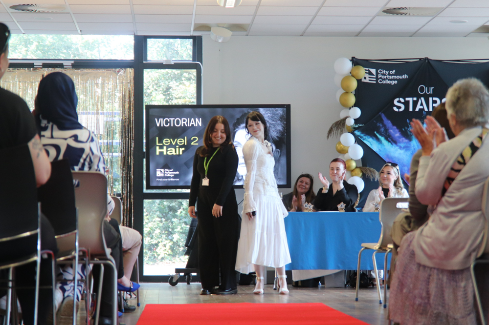 Female students showing off their finished looks at the Hair and Beauty Awards at COPC 