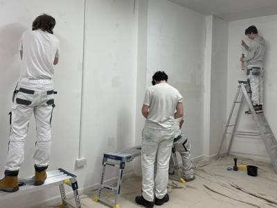 Painting and Decorating students preparing a wall ready for painting at DEBRA Southsea