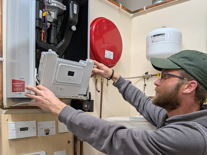 A gas trainee interacting with a boiler system.