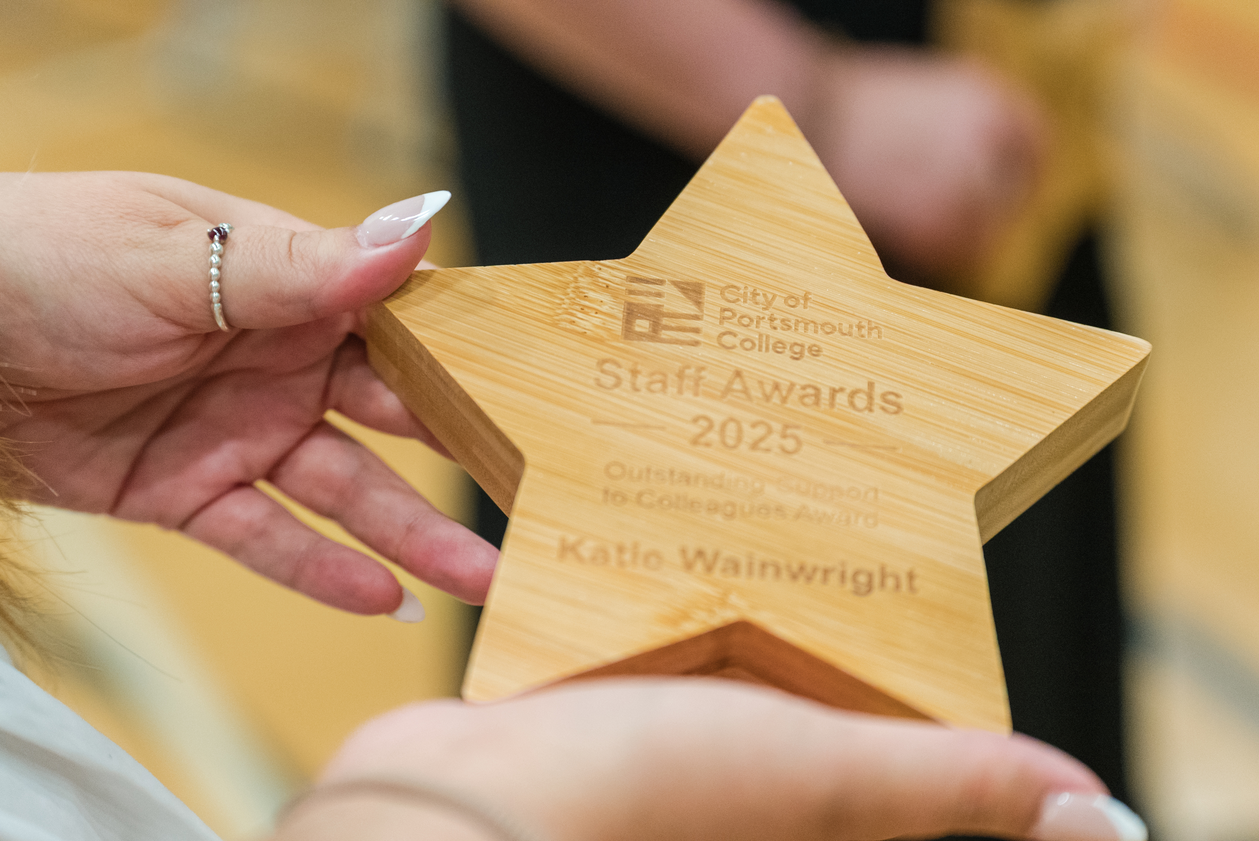 A star shaped wooden trophy for the staff awards at City of Portsmouth College 