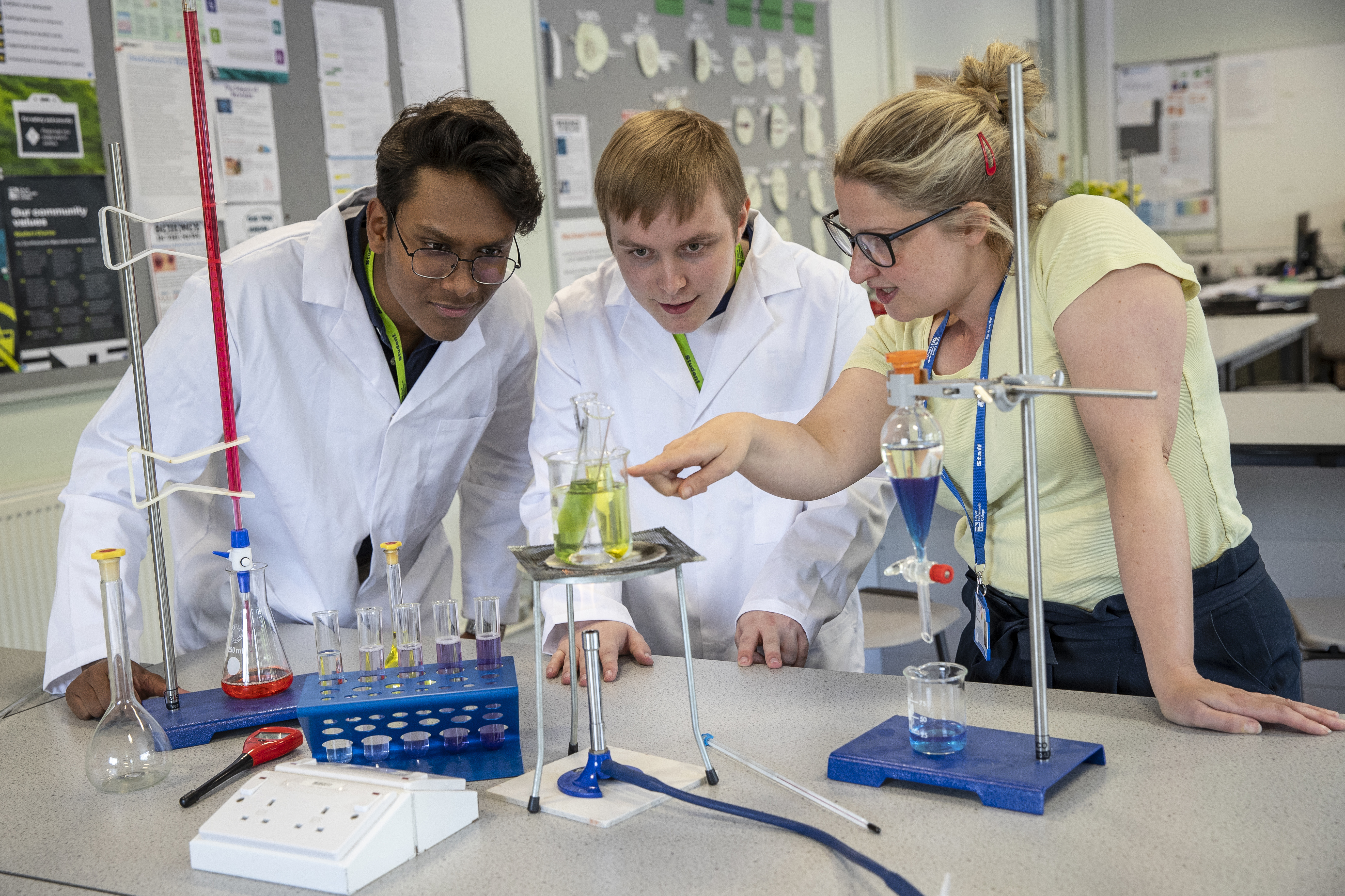 Two students and a lecturer undertaking a science experiment at City of Portsmouth College 