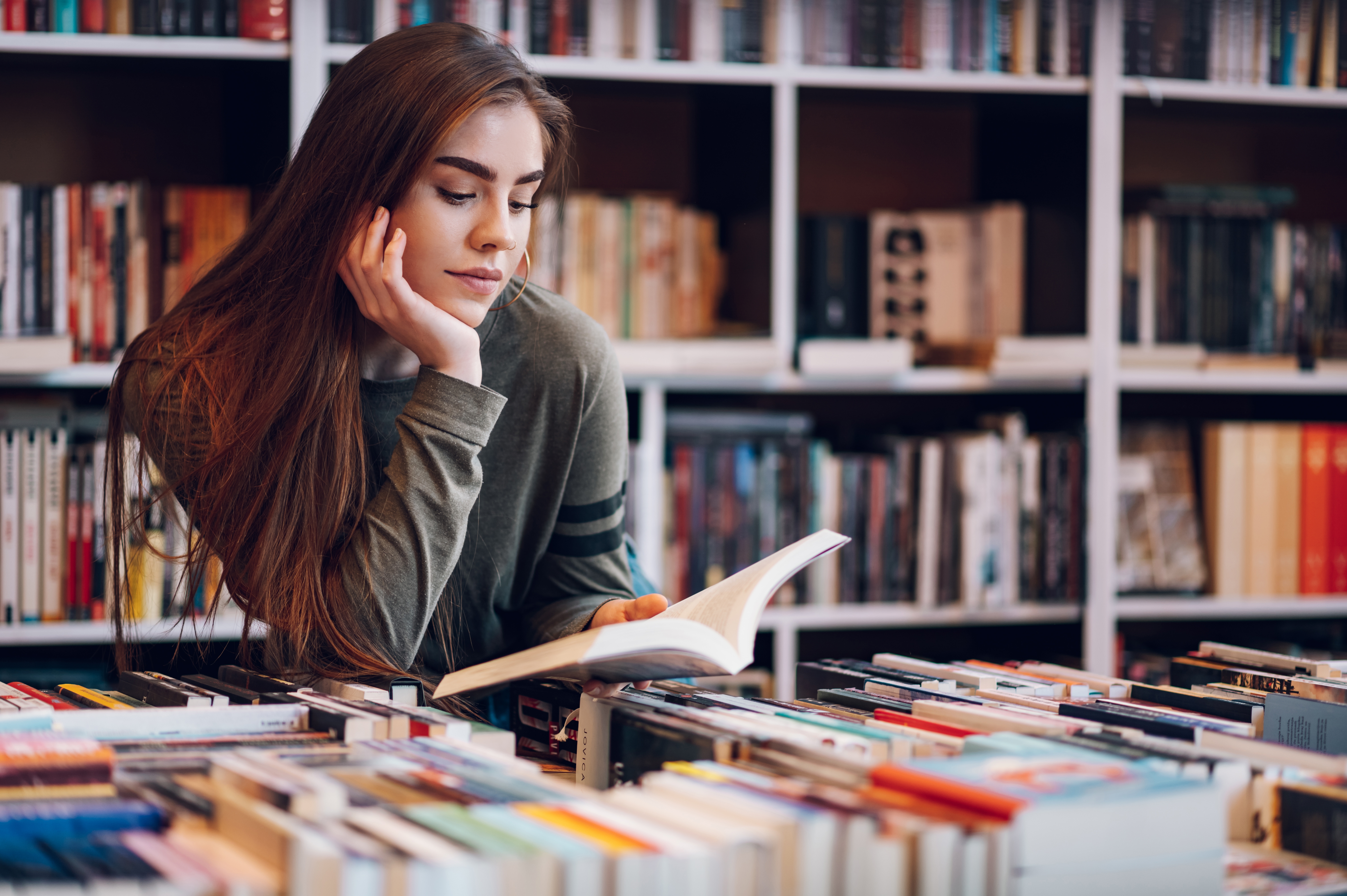 Female student reading book in the library