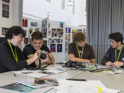 Photography students working in a classroom at a table 