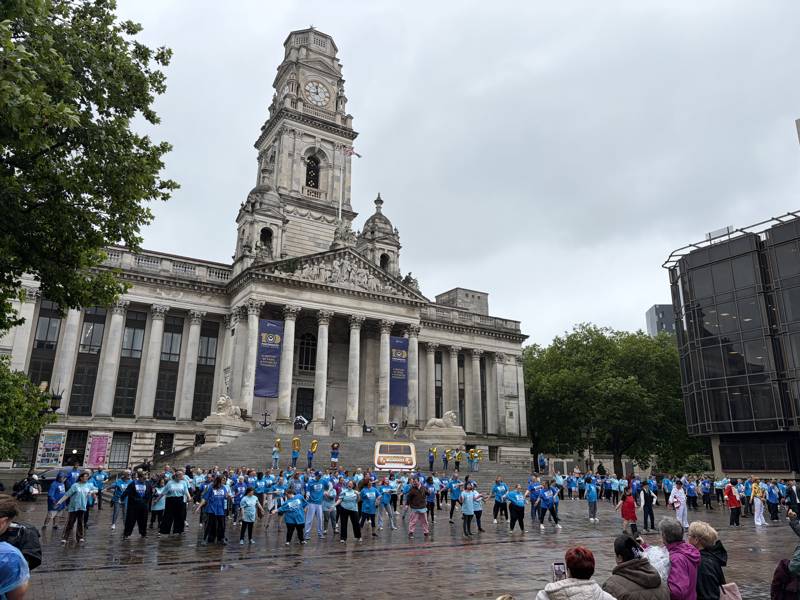 A panoramic shot of Portsmouth's Guildhall Square. In front are 250 performers in the finale of their Portsmouth 100 flashmob dance.