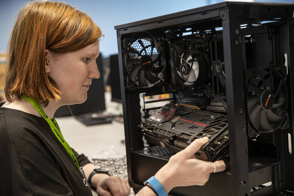 A female student building a computer tower