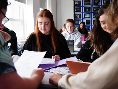 Students at work in a classroom at their desks 