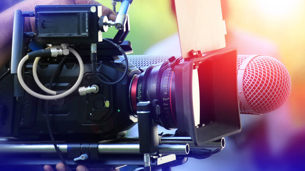 Videographer working with professional equipment in movie production