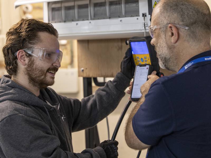 A student gets tuition from a lecturer in Refrigeration and Air Conditioning