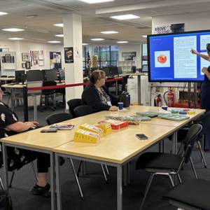 A staff members gives a presentation to colleagues at the ATTL