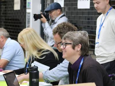 COPC staff handing out results to students