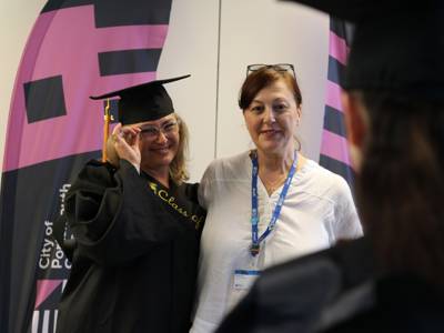 An ESOL Level 2 graduate poses with a staff member