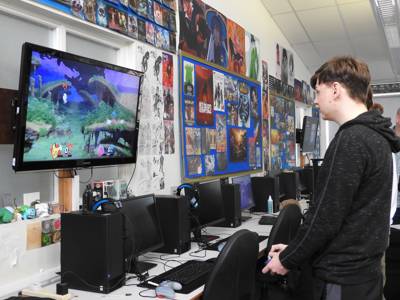 A young man plays a video game