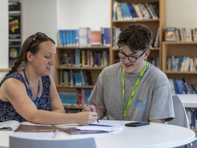 Student receiving one-to-one support from a member of college staff in the Highbury Campus Student Hub