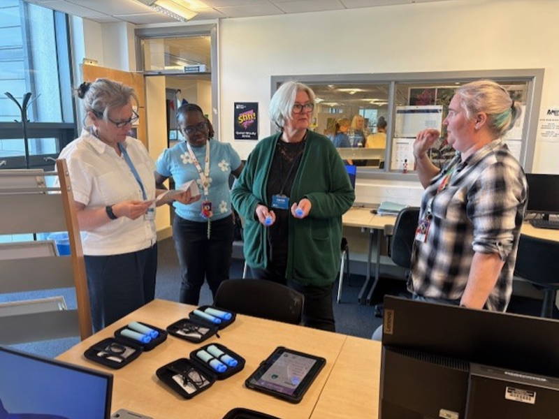 A group of local education providers test assistive technology at the launch of the Assistive Technology Lending Library at City of Portsmouth College