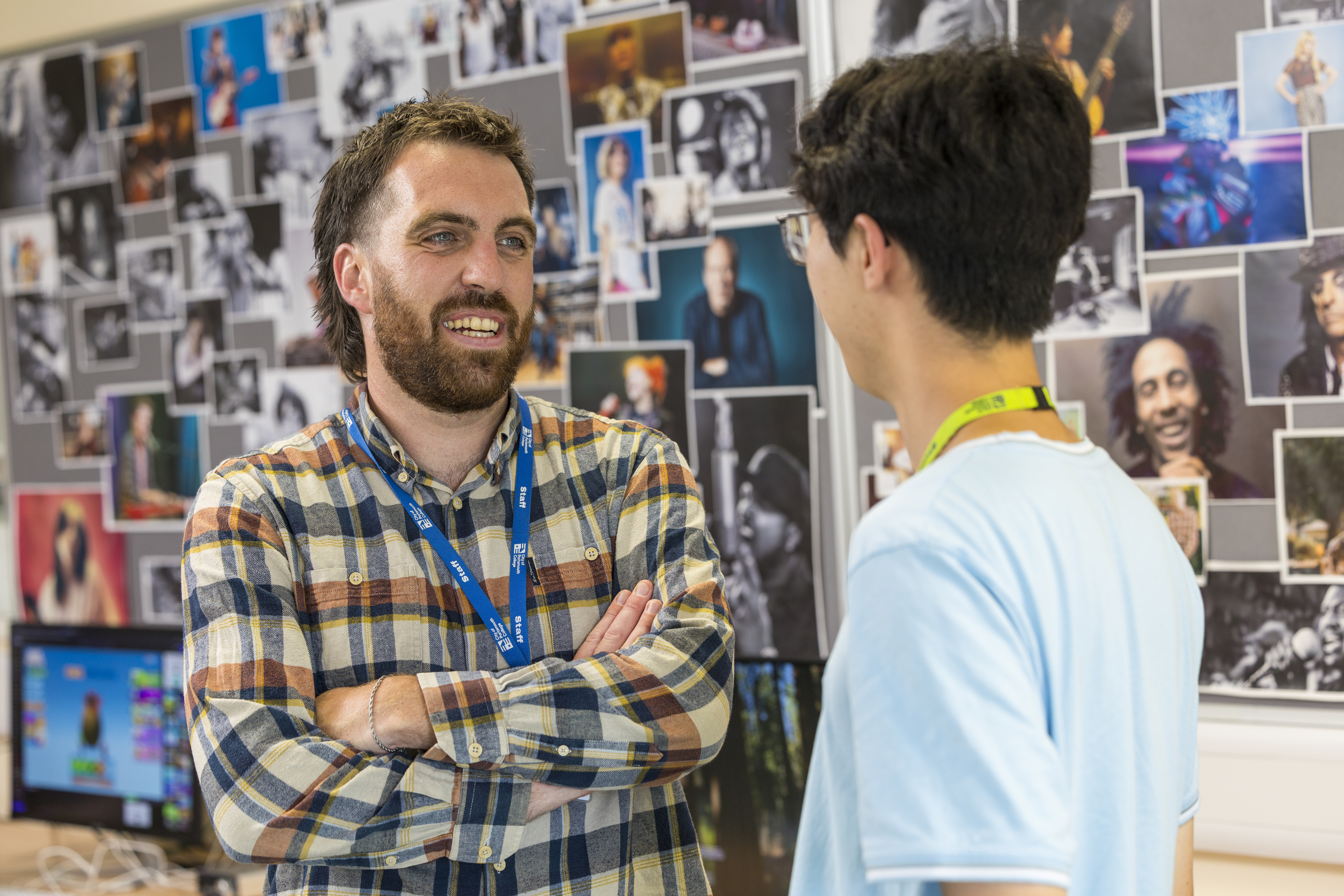 A music lecturer chatting with a student at City of Portsmouth College 