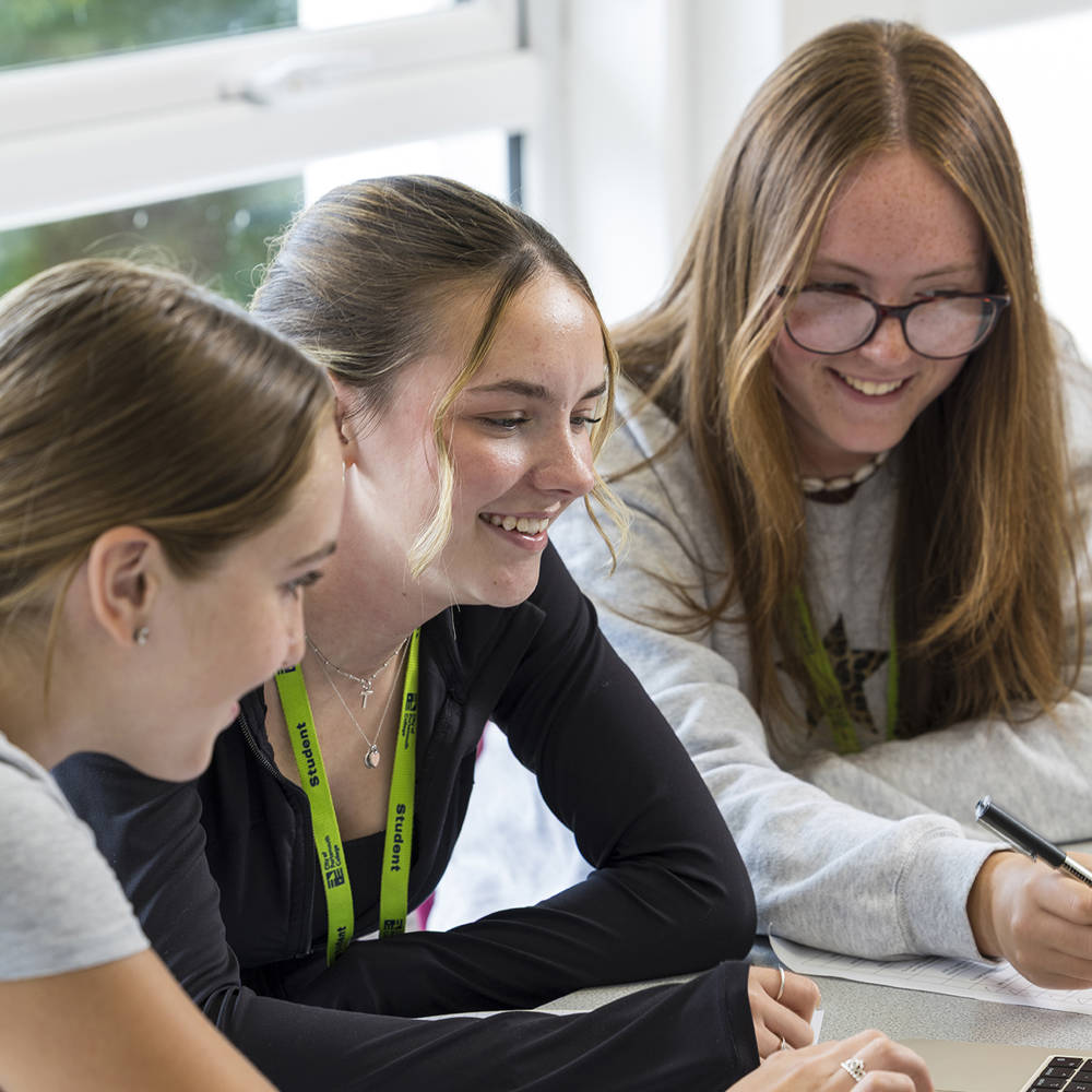 Students working together in a classroom during Welcome Day, building confidence and connections before starting college.