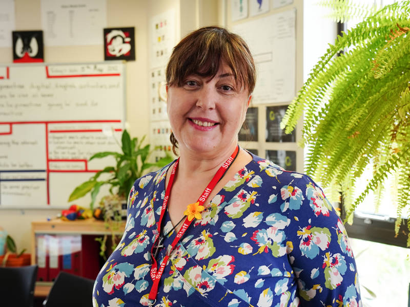 Smiling female ESOL lecturer.