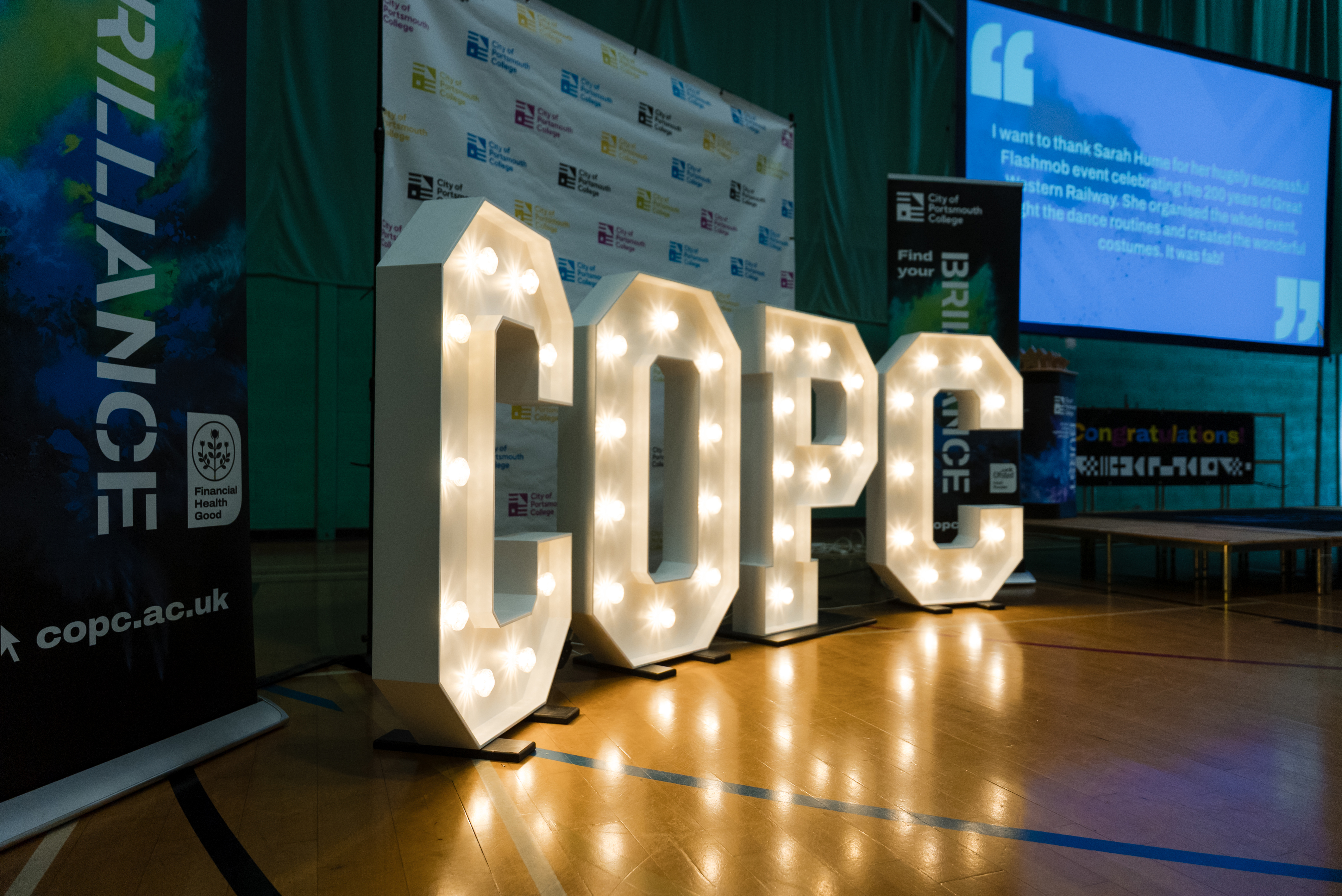 COPC in light up letters at the staff awards at City of Portsmouth College 