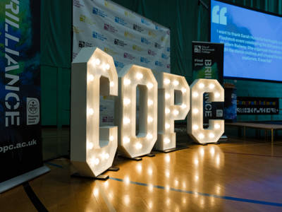 COPC in light up letters at the staff awards at City of Portsmouth College