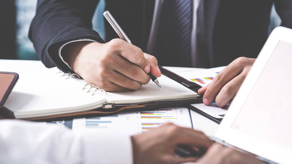 Business adviser analysing financial figures denoting the progress in the work of the company