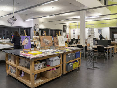 An art and design classroom with artwork displayed at City of Portsmouth College 