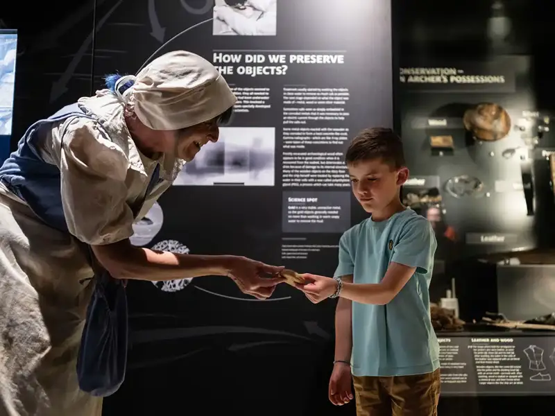 A child interacting with a costumed staff member at The Mary Rose museum 