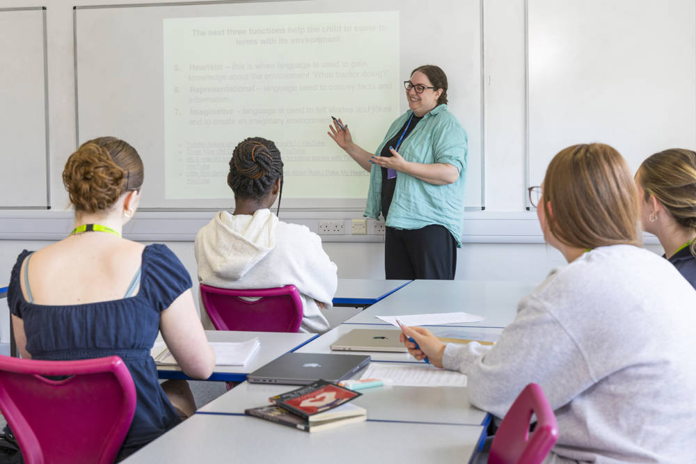 A female lecturer presenting to her English class