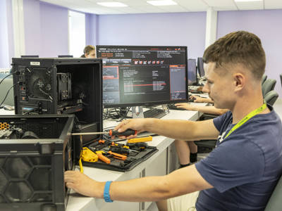 IT student repairing desktop computers in the Highbury Campus IT suite