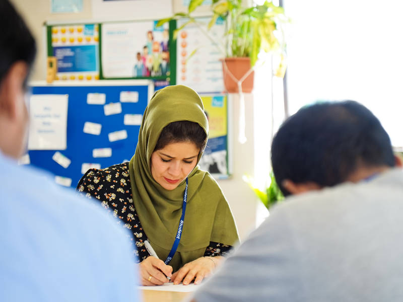 Female student seen studying in an ESOL lesson.