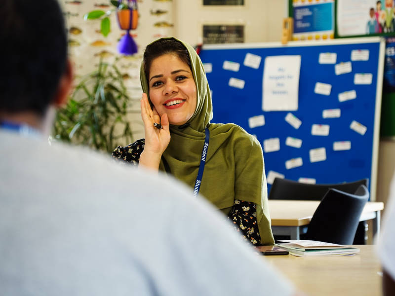 Female student wearing head scarf smiling